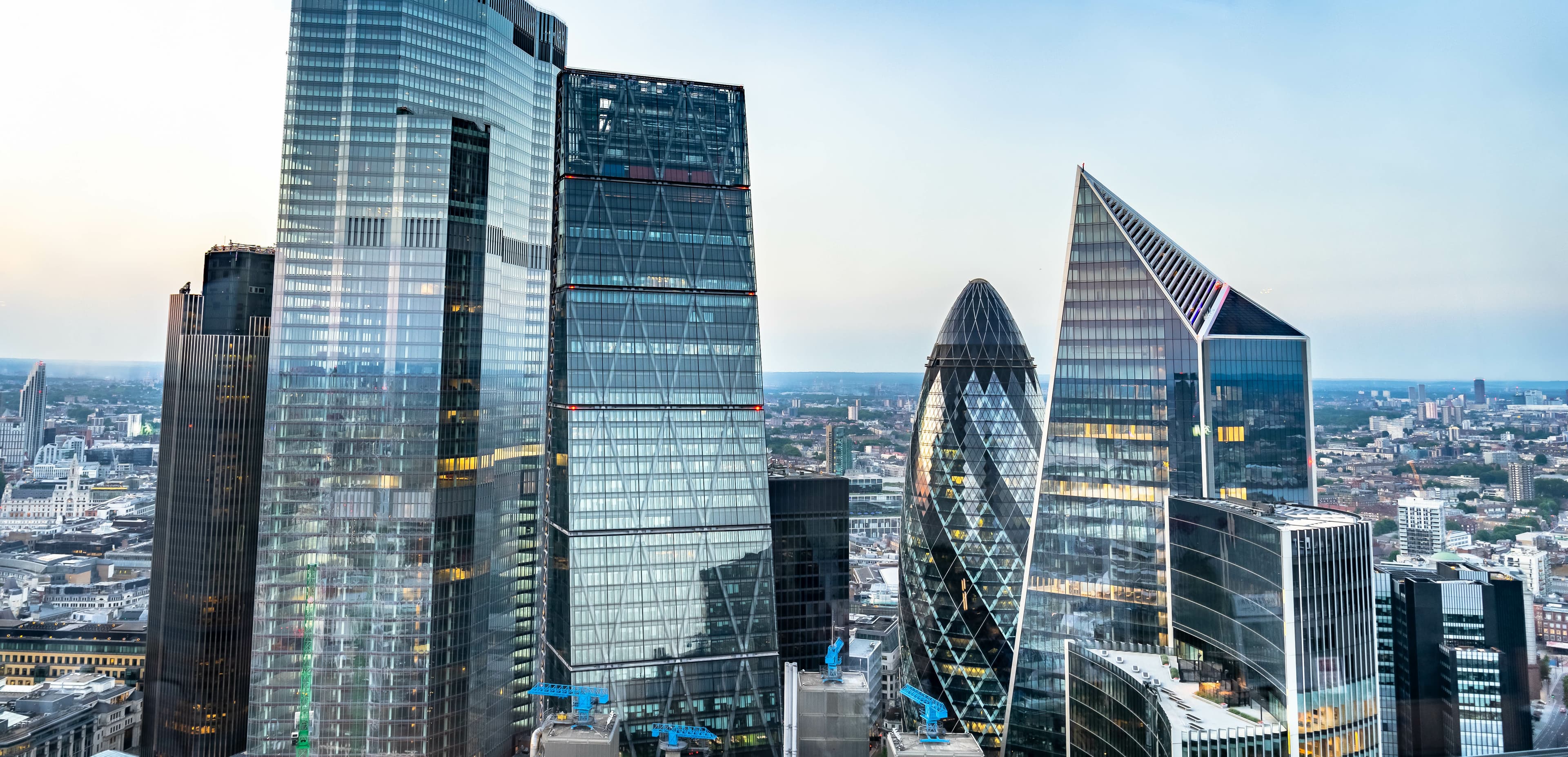 Panoramic London city skyline with the Thames and iconic skyscrapers like The Shard and other modern buildings